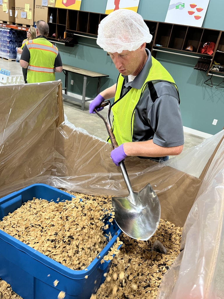 Staff member stirring cereal with shovel